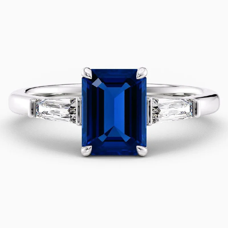 women’s engagement rings with emerald and sapphire pave settings-2 Carat Emerald Shape Three Stone Blue Sapphire Engagement Ring